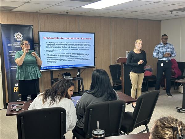 AIDB Birmingham Interpreter Coordinator Emily Cain and Staff Interpreter Lydia Leno interpret for a workshop on Employment Discrimination with Federal investigator Cortise Miles.